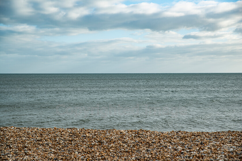 lyme-057 
 Lyme Regis and Uplyme riverside walk 
 Keywords: Lyme Regis, Uplyme, coastal town, Devon, Dorset, boarder, riverwalk, seaside, sea view, beach, stone beach, pebble beach, sea, waves, calm, choppy, sky, clouds